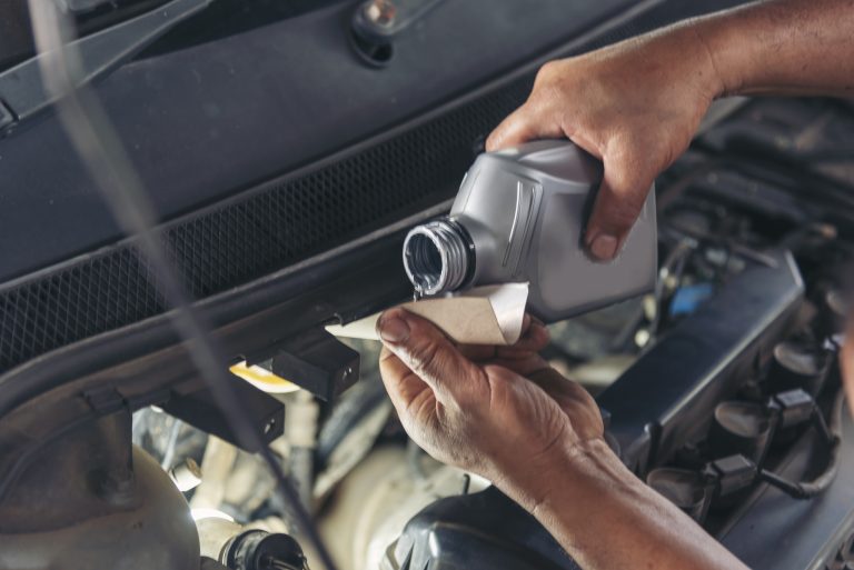 Mechanic man hands repairing car shop
